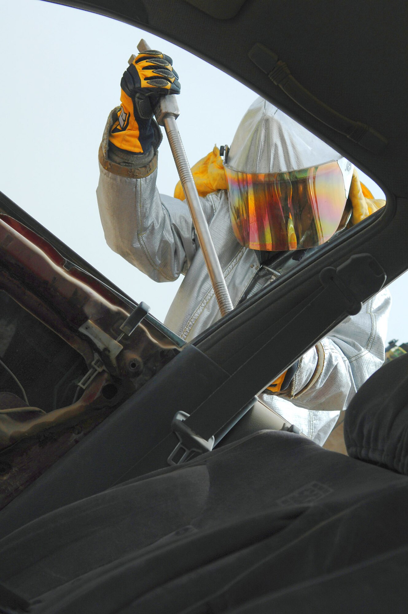 Army Pfc. Doug Desbrough pries open the door of a vehicle during vehicle extrication training April 5 at Balad Air Base, Iraq. Army and 332nd Air Expeditionary Wing Air Force firefighters work jointly at the fire station here, which is conducive to quick reaction times and requires less coordination during emergency situations. Private Desbrough is a 8th Ordnance Company firefighter trainee deployed from Fort Bragg, N.C. (U.S. Air Force photo/Senior Airman Julianne Showalter) 
