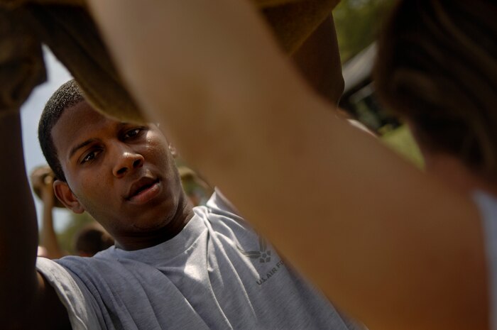 Jamaal Avington and Tomsanna Farley hold up sand bags waiting for thier turn to do push-ups and sit-ups during the Commander's Fitness Challenge April 4. Avington and Farley represented the 437th Mission Support Squadron team. (U.S. Air Force photo/Senior Airman Nicholas Pilch)
