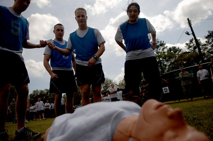 Justin Ellsworth, Matthew Baldyga, Daniel Graham and Xochiquetzal Baldwin are preparing to treat a self-aid buddy care dummy with simulated internal bruising April 4. Ellsworth, Baldyga, Graham and Baldwin are all with the 437th Communications Squadron.   (U.S. Air Force photo/Senior Airman Nicholas Pilch)
