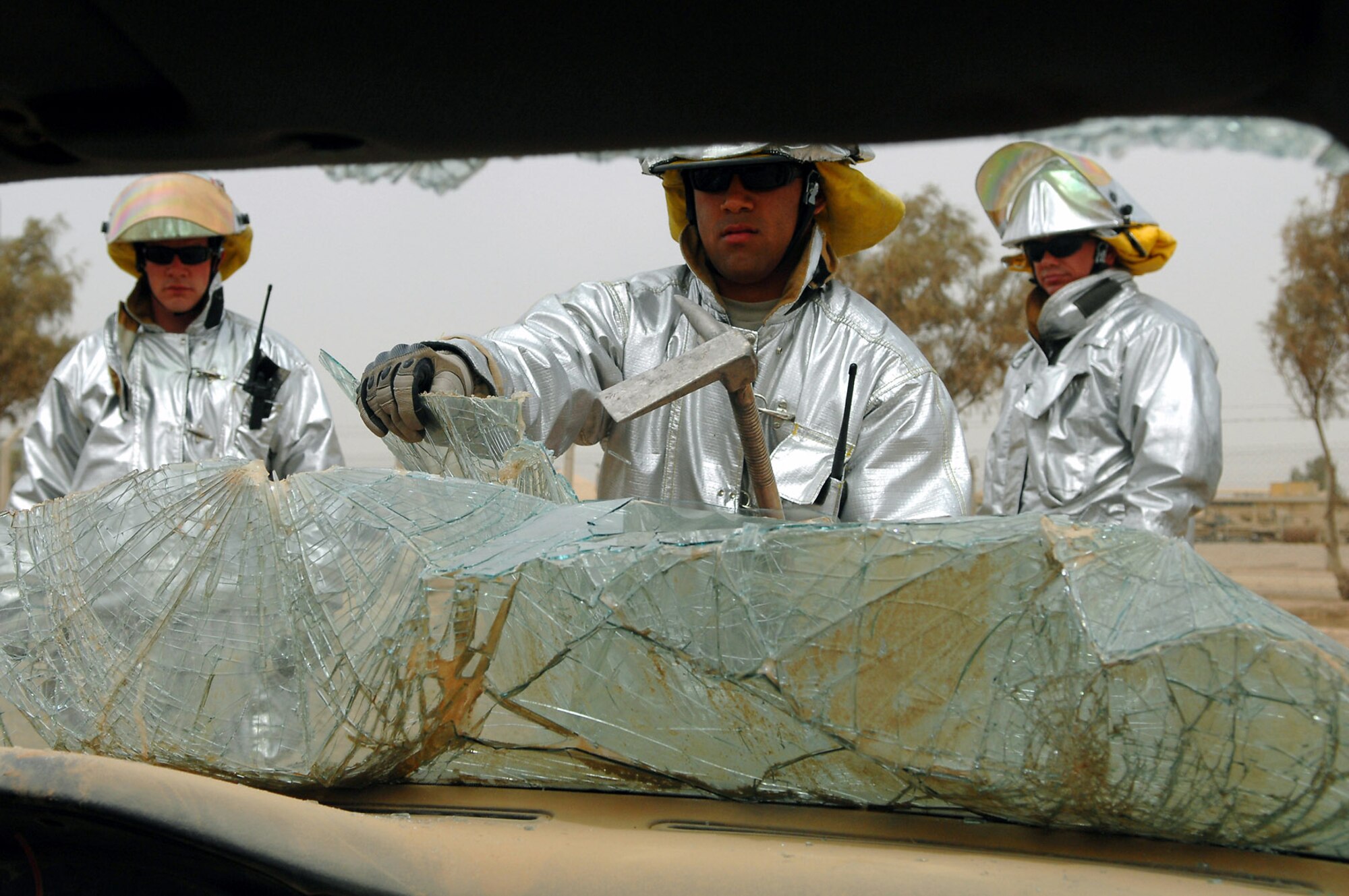 Airman 1st Class Matthew Kahai pulls out a windshield of a car during vehicle extrication training April 5 at Balad Air Base, Iraq. This exercise teaches firefighters how to rescue victims from wreckage. Constant training enables the firefighters to keep their skills sharp and be prepared for emergencies. Airman Kahai is a 332nd Expeditionary Civil Engineer Squadron firefighter deployed from Minot Air Force Base, N.D. (U.S. Air Force photo/Senior Airman Julianne Showalter) 
