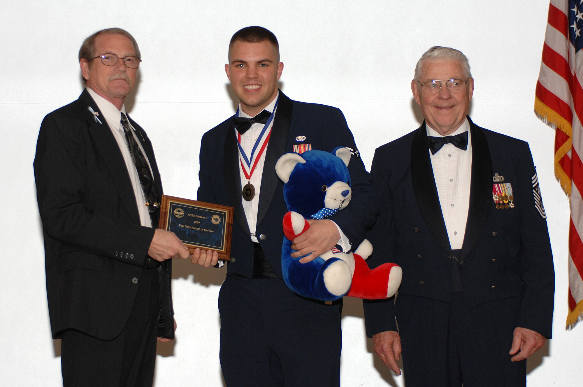 LANGLEY AIR FORCE BASE, Va. -- Mr. Raymond Wiltshire, Air Force Sergeants Association Division 3 president (left) and retired Chief Master Sgt. of the Air Force Robert Gaylor (right) present Airman 1st Class Ryan Rowden,10th Intelligence Squadron supply technician, the award of AFSA Division 3 First Term Airman of the Year. The award was presented at AFSA’s Annual Awards and Installation Banquet in Newport News, Va., April 5. The banquet concluded the three-day AFSA Convention and Professional Airman's Conference. (U.S. Air Force photo/Tech. Sgt. April Wickes)