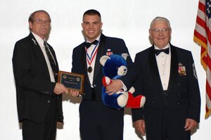 LANGLEY AIR FORCE BASE, Va. -- Mr. Raymond Wiltshire, Air Force Sergeants Association Division 3 president (left) and retired Chief Master Sgt. of the Air Force Robert Gaylor (right) present Airman 1st Class Ryan Rowden,10th Intelligence Squadron supply technician, the award of AFSA Division 3 First Term Airman of the Year. The award was presented at AFSA’s Annual Awards and Installation Banquet in Newport News, Va., April 5. The banquet concluded the three-day AFSA Convention and Professional Airman's Conference. (U.S. Air Force photo/Tech. Sgt. April Wickes)