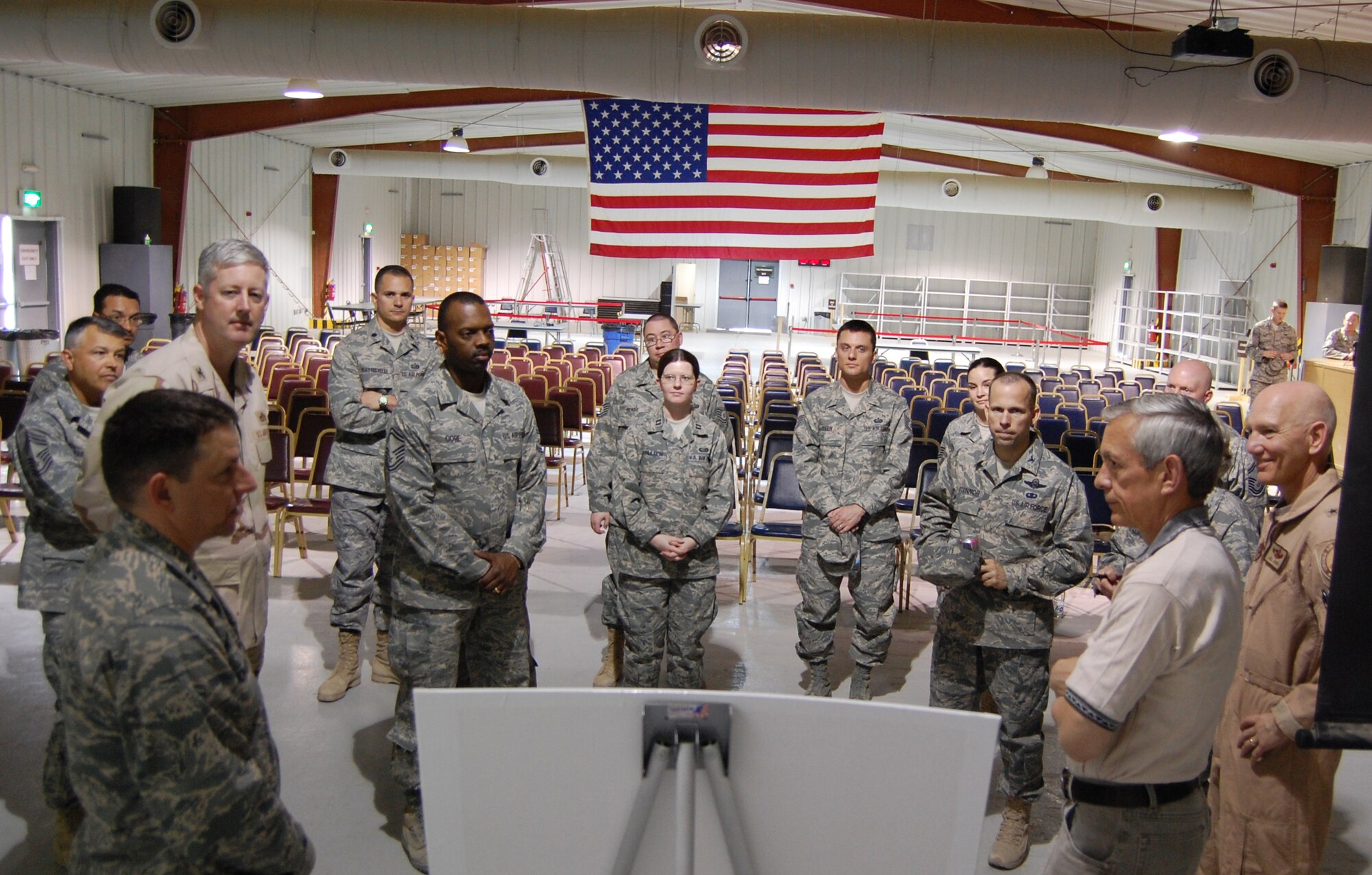SOUTHWEST ASIA -- The Honorable Craig Duehring, the Assistant Secretary of the Air Force for Manpower and Reserve Affairs, Washington, D.C., receives a briefing from Capt. Robert Johnson, (bottom left), following an open forum at an air base in the Persian Gulf Region recently. Captain Johnson, the 386th Expeditionary Mission Support Group personnel support for contingency operations team chief, provided Mr. Duehring, Brig. Gen. William Busby, and Col. Anne Hamilton, an overview of how the wing accounts for all incoming and outgoing Airmen in the deployed theater and works with other deployed wings and groups to ensure every Airman gets to where they're needed with minimal delay. (Air Force photo/Tech. Sgt. Michael O'Connor)

