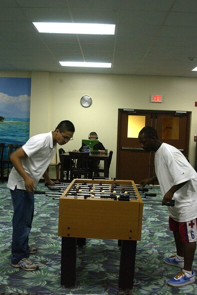 Airman Ho Leung, 36th Secuirty Forces Sqaudron and military spouse Lewis Hariss play a competitive game of foosball at the First Sergeant Hot Spot Tournament held Apr. 4 at the Hot Spot. (U.S. Air Force photo by Airman 1st Class Carissa Wolff)