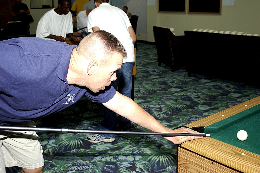 35th Civil Engineering Squadron First Sergeant, Master Sergeant Kevin Owens debates on what his beast shot on the pool table is at the First Sergeant Hot Spot Tournament held Apr. 4 at the Hot Spot. (U.S. Air Force photo by Airman 1st Class Carissa Wolff)