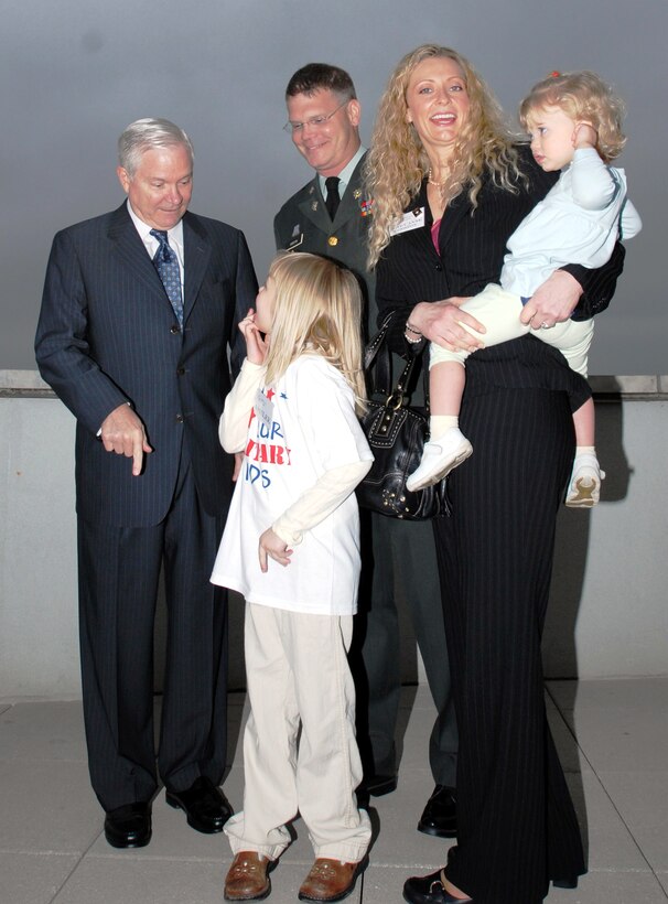 Ashlee Godston, 5, talks with Defense Secretary Robert M. Gates. Ashlee and her family -- Army Lt. Col. Pete Godston, center, his wife, Mary Anne, and their younger daughter, Annika, 20 months -- met with Gates April 7, 2008, during a reception hosted by Our Military Kids, an organization that awards small grants to children of deployed National Guardsmen and reservists for extracurricular activities. Photo by Samantha L. Quigley, Department of Defense