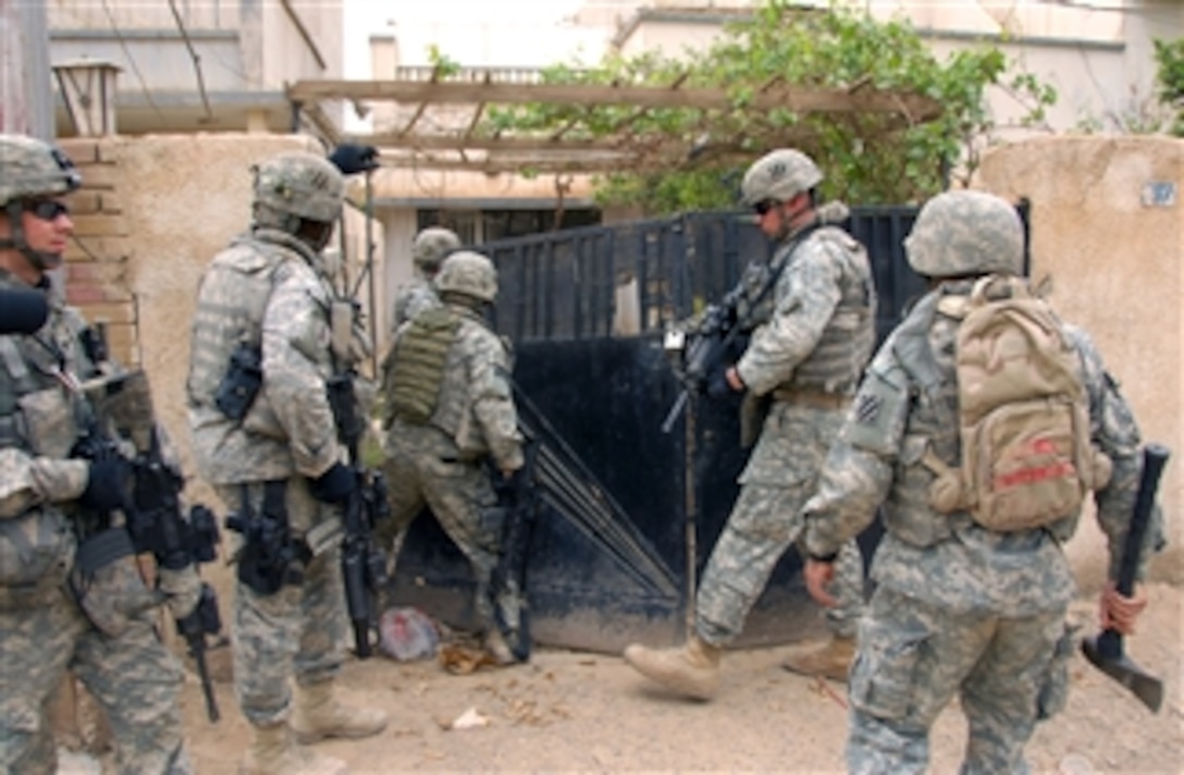 U.S. Army soldiers search an abandoned house for weapons and illegal materials during a patrol in Haidraq, Iraq, April 6, 2008. The soldiers are assigned to the 101st Airborne Division's, 3rd Infantry Division, 1st Battalion, 64th Field Artillery, 2nd Brigade Combat Team.