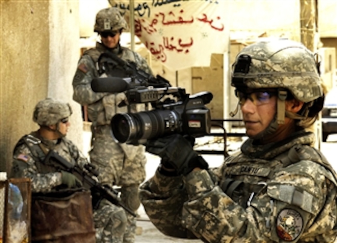 U.S. Air Force Staff Sgt. Vilma Cantu, a combat camera videographer with 37th Communications Squadron, Lackland Air Force Base, Texas, documents U.S. soldiers with the 4th Infantry Division's 4th Battalion, 10th Cavalry Regiment, 2nd Brigade Combat Team, as they patrol in Amiriyah, Iraq, April 4, 2008. 