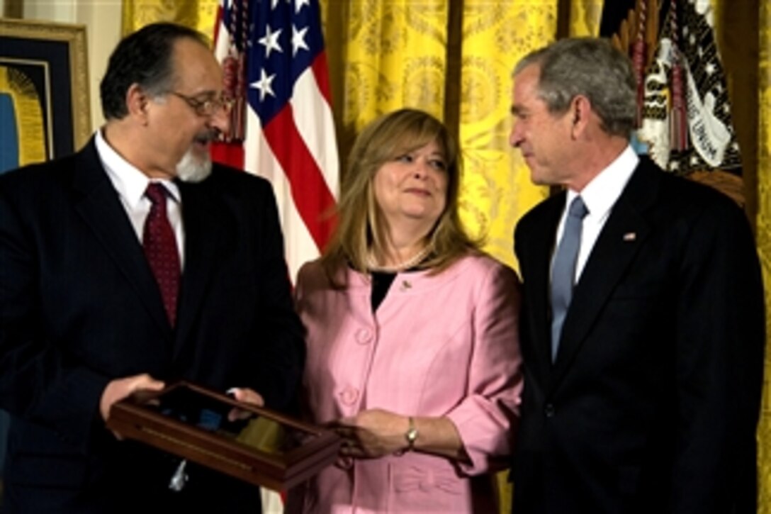 George and Sally Monsoor speak with President George W. Bush during a Medal of Honor presentation ceremony at the White House, April 8, 2008, in honor of their son U.S. Navy Petty Officer 2nd Class Michael A. Monsoor. 