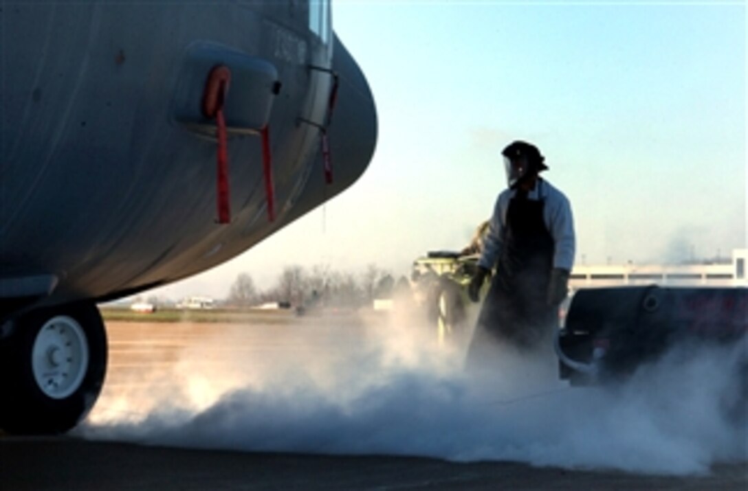 U.S. Air Force Senior Airman Andrew Cunningham finishes uploading liquid oxygen into a C-130H Hercules aircraft on the flight line of Yeager Air Guard Station in Charleston, W.Va., April 6, 2008. The base is home to 130th Airlift Wing, West Virginia Air National Guard.