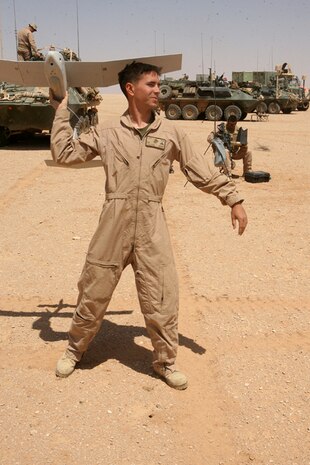 Lance Cpl. Basil M. Callahan, a welder with Charlie Company, 2nd Light Armored Reconnaissance Battalion, Regimental Combat Team 5, throws the Raven for it to take off during a system test in western Anbar province, Iraq, April 8. Several Marines from 2nd LAR learned to fly the Unmanned Air Vehicle when they arrived in Camp Korean Village, Iraq, to better serve their companies as UAV operators.