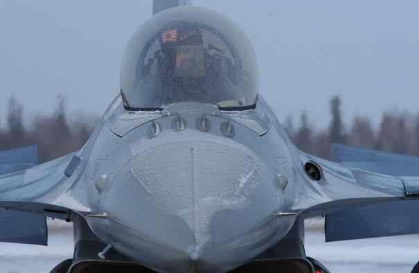Capt. Bryan Spence controls the flaps and rudder on an F-16 Fighting Falcon during a pre-flight inspection to ensure all ice build up has been melted for maximum aerodynamic performance before a RED FLAG-Alaska 08-2 training mission April 8 at Eielson Air Force Base, Alaska. RED FLAG-Alaska is a Pacific Air Forces command directed field training exercise which provides joint offensive counter-air, interdiction, close air support, and large force employment training in a simulated combat environment. He is assigned to Misawa Air Base, Japan. (U.S. Air Force Photo/Airman 1st Class Jonathan Snyder)