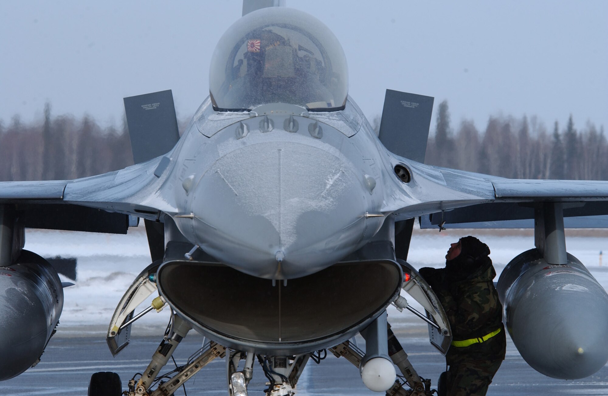 Capt. Bryan Spence, cockpit, controls the flaps on an F-16 Fighting Falcon while Staff Sgt. Allen Duryee monitors to confirm the flaps are working properly during a pre-flight inspection before a RED FLAG-Alaska 08-2 training mission April 8 at Eielson Air Force Base, Alaska. RED FLAG-Alaska is a Pacific Air Forces command directed field training exercise, which provides joint offensive counter-air, interdiction, close air support, and large force employment training in a simulated combat environment. Both are assigned to Misawa Air Base, Japan. (U.S. Air Force Photo/Airman 1st Class Jonathan Snyder)