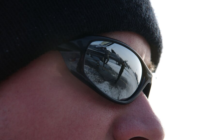 Airman 1st Class Danny Reynolds watches Capt. Bryan Spence climb into an F-16 Fighting Falcon during pre-flight inspection process which ensures maximum aerodynamic performance of the aircraft while in flight April 8 at Eielson Air Force Base, Alaska. RED FLAG-Alaska 08-2 is a Pacific Air Forces command directed field training exercise which provides joint offensive counter-air, interdiction, close air support, and large force employment training in a simulated combat environment. Both are assigned to Misawa Air Base, Japan. (U.S. Air Force Photo/Airman 1st Class Jonathan Snyder) (Released)