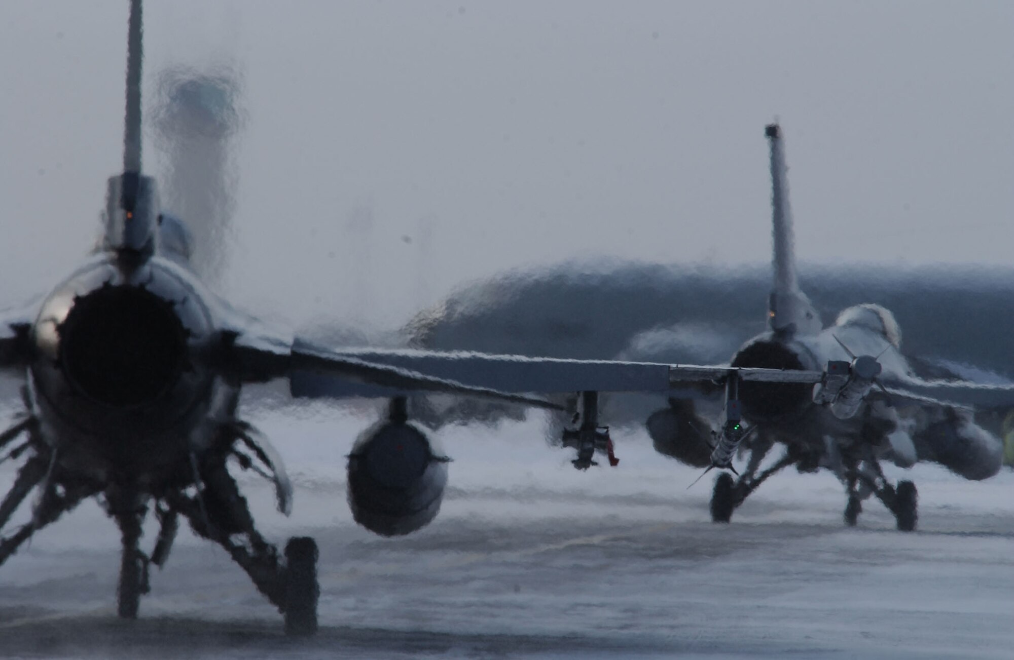 Two F-16 Fighting Falcon taxi down the flightline prior to a training mission April 8 at Eielson Air Force Base, Alaska. RED FLAG-Alaska 08-2 is a Pacific Air Forces command directed field training exercise which provides joint offensive counter-air, interdiction, close air support, and large force employment training in a simulated combat environment. Both are assigned to Misawa Air Base, Japan. (U.S. Air Force Photo/Airman 1st Class Jonathan Snyder) (Released)