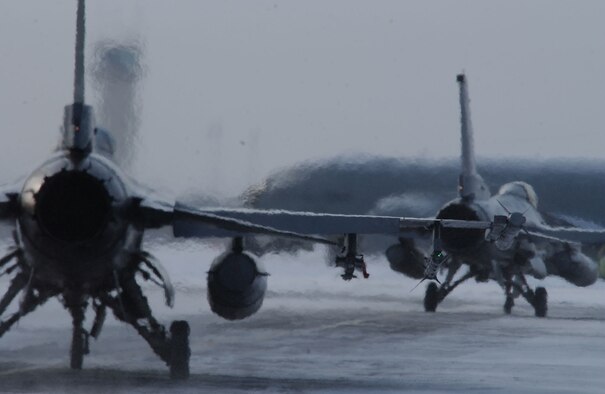 Two F-16 Fighting Falcon taxi down the flightline prior to a training mission April 8 at Eielson Air Force Base, Alaska. RED FLAG-Alaska 08-2 is a Pacific Air Forces command directed field training exercise which provides joint offensive counter-air, interdiction, close air support, and large force employment training in a simulated combat environment. Both are assigned to Misawa Air Base, Japan. (U.S. Air Force Photo/Airman 1st Class Jonathan Snyder) (Released)