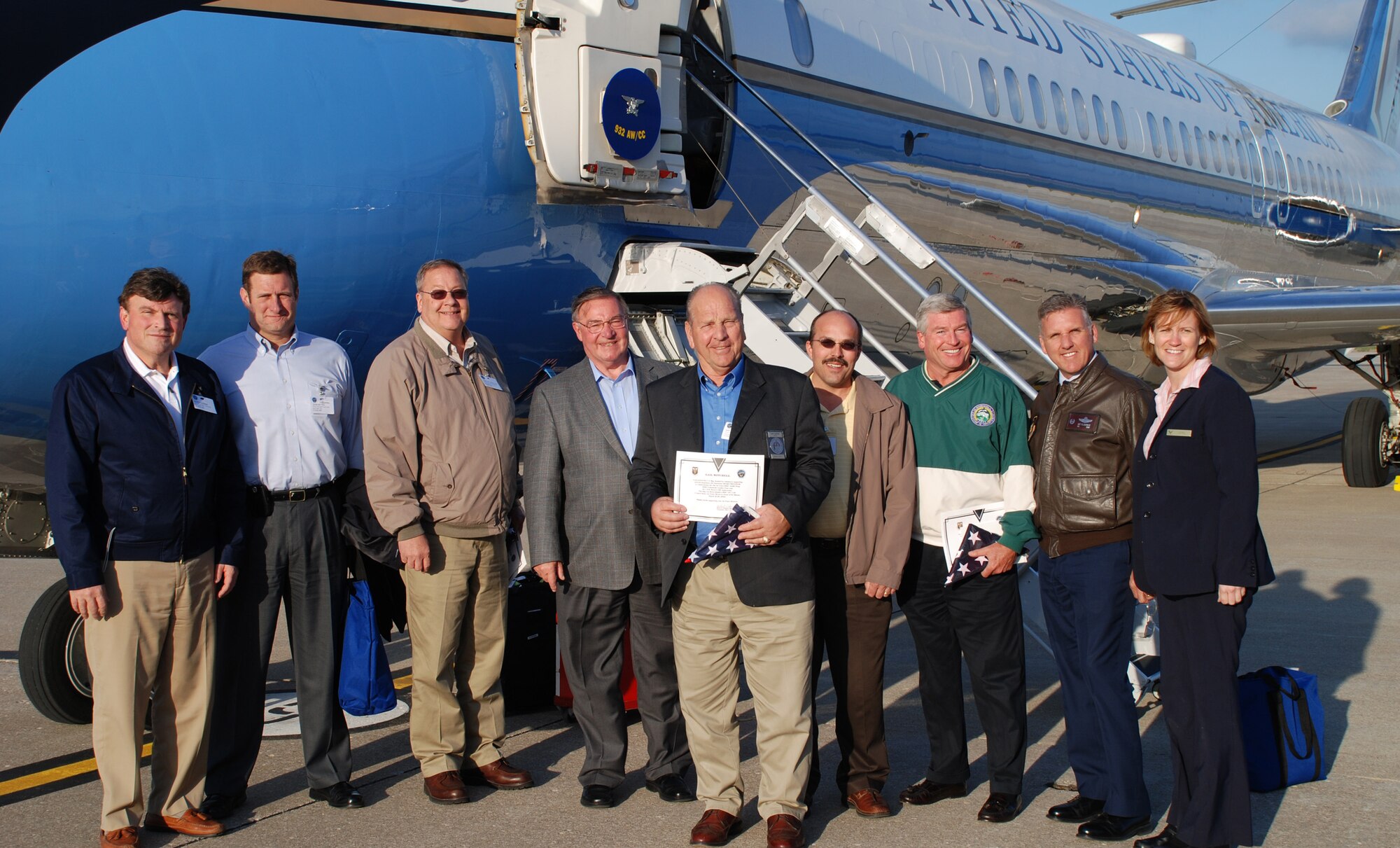 Col. Jay Flournoy (second from right in leather jacket), commander of the Air Force Reserve Command's distinguished visitor flying mission, helped welcome civic leaders back to the ground after an orientation flight to explain the C-9C mission.  Local leaders included mayors, business owners and civic leaders from a variety of backgrounds.  Standing at the far right is Tech Sgt. April Tarbill, one of the flight attendants who prepared meals aboard the flight.  Photo/Capt. Stan Paregien