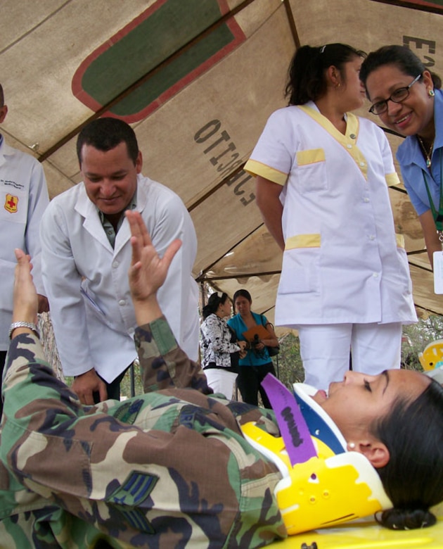 SOTO CANO AIR BASE, Honduras?Wearing a cervical spine collar, Senior Airman Yaritza Liriana, Joint Task Force-Bravo medical technician, reviews proper litter transfer procedures for people with spinal chord injuries to Honduran medical personnel during an medical information exchange. (U.S. Air Force photo by Tech. Sgt. William Farrow)  