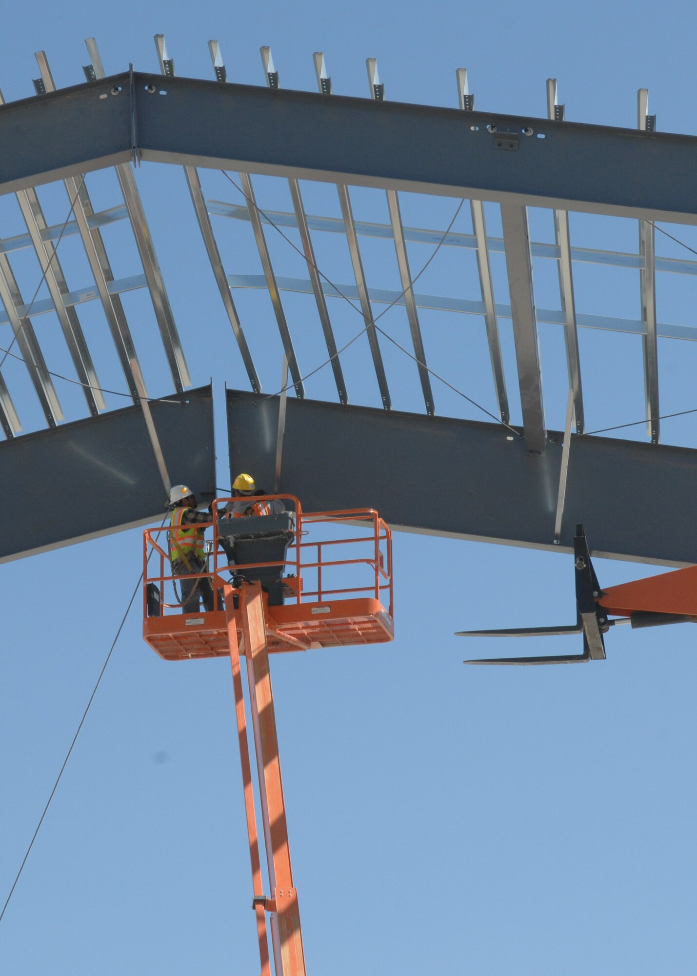 CANNON AIR FORCE BASE N.M--Butler Construction company drives a support pin to join the first section of the new hanger on the flightline.  This hanger is one of three hangers under construction for the 27th Special Operations Wing.  (U.S. Air Force photo by A1C James R. Bell)