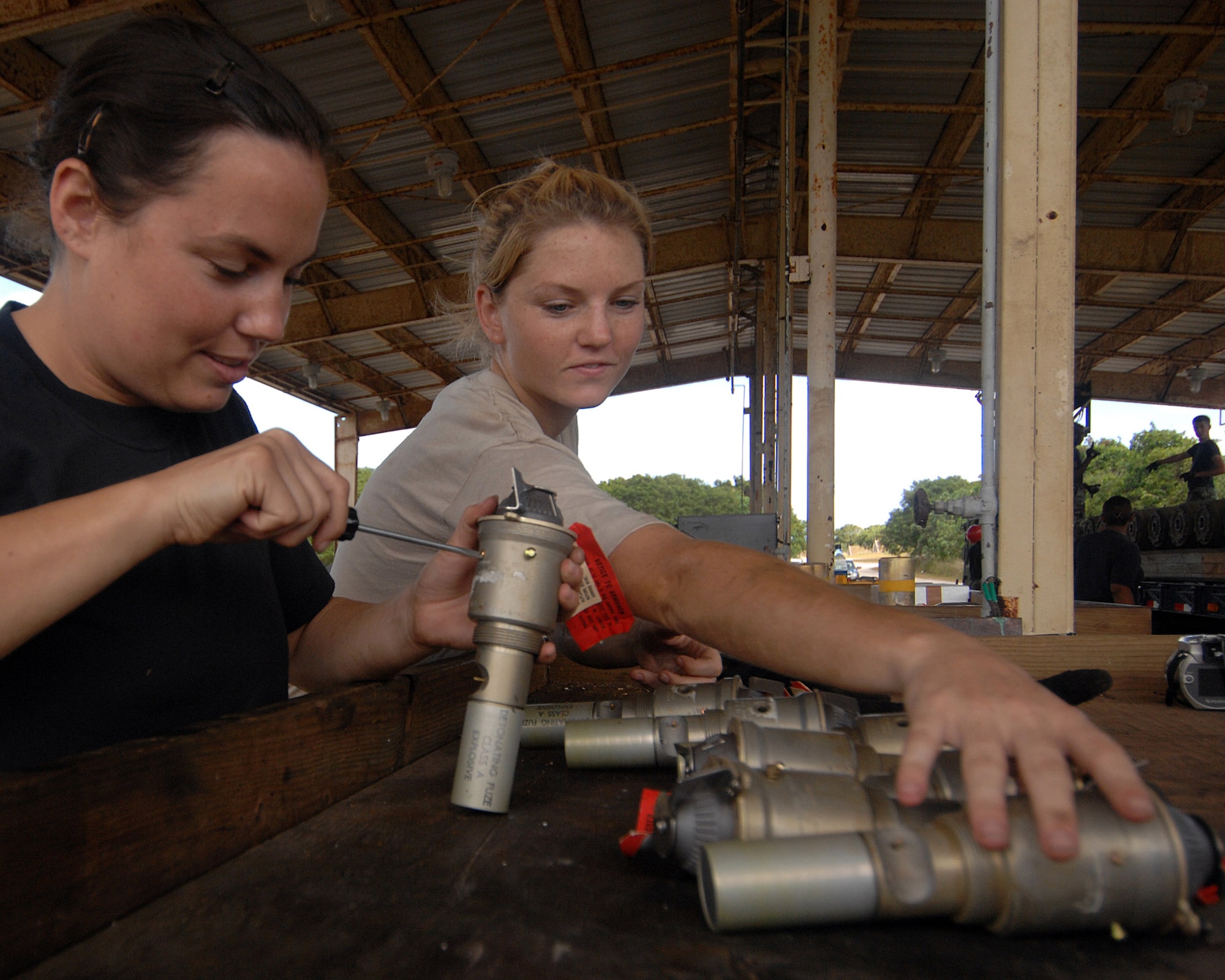 Senior Airman Julia Unsworth and Airman First Class Casey Carrano inspect nose fuzes before inserting them into bombs.  Airmen in the 36th Munitions Squadron at Andersen Air Force Base, Guam, are assembling free-fall, unguided, general purpose 750-pound bombs that will eventually be loaded on a B-52 Stratofortress. In a conventional conflict, the B-52 can carry nuclear or precision-guided conventional ordnance with worldwide precision navigation capability. capability. Airman Unsworth is deployed from the 2nd Maintenance Group from Barksdale AFB, La., and Airman Carrano is with the 36th MS at Andersen AFB. (U.S. Air Force photo/Staff Sgt. Vanessa Valentine)