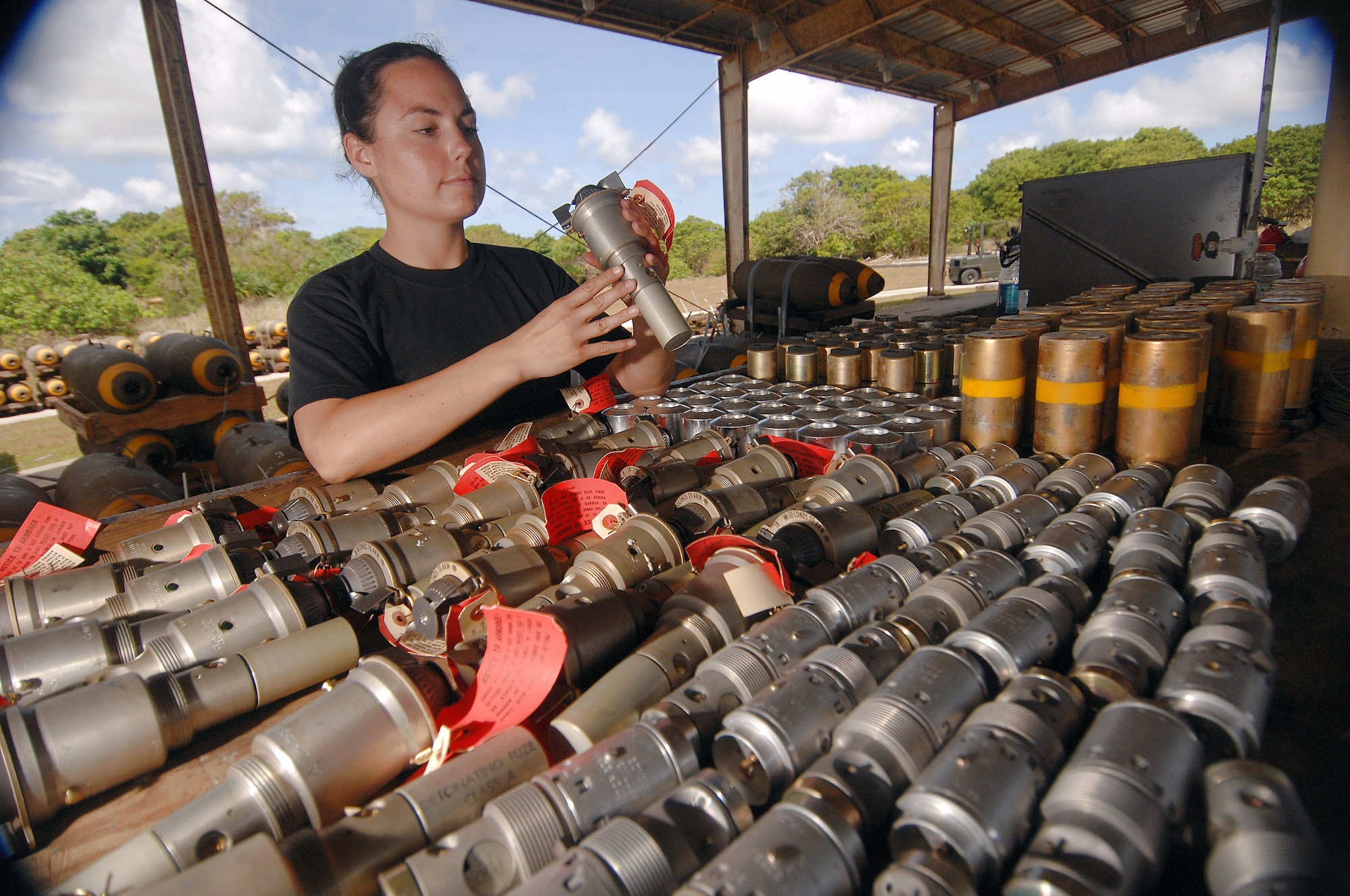 Senior Airman Julia Unsworth inspects nose fuzes before inserting them into bombs.  Airmen in the 36th Munitions Squadron at Andersen Air Force Base, Guam, are assembling free-fall, unguided, general purpose 750-pound bombs that will eventually be loaded on a B-52 Stratofortress. In a conventional conflict, the B-52 can carry nuclear or precision-guided conventional ordnance with worldwide precision navigation capability.  Airman Unsworth is deployed from the 2nd Maintenance Group at Barksdale AFB, La. (U.S. Air Force photo/Staff Sgt. Vanessa Valentine) 