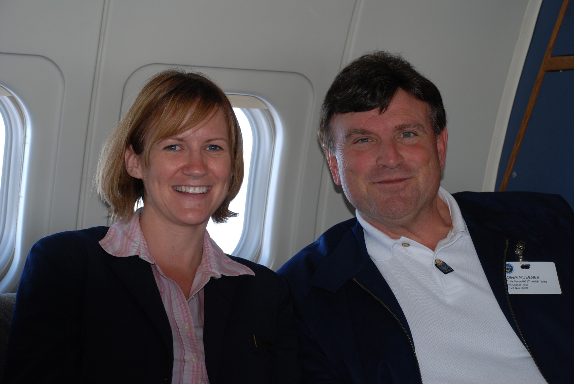 Flight attendant Tech Sgt. April Tarbill enjoys a humorous moment with a civic leader aboard the C-9C.  She served Illinois civic leaders a refreshment and information about the 932nd Airlift Wing during a recent flight to showcase the Air Force Reserve.