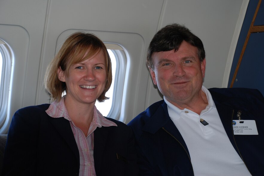 Flight attendant Tech Sgt. April Tarbill enjoys a humorous moment with a civic leader aboard the C-9C.  She served Illinois civic leaders a refreshment and information about the 932nd Airlift Wing during a recent flight to showcase the Air Force Reserve.