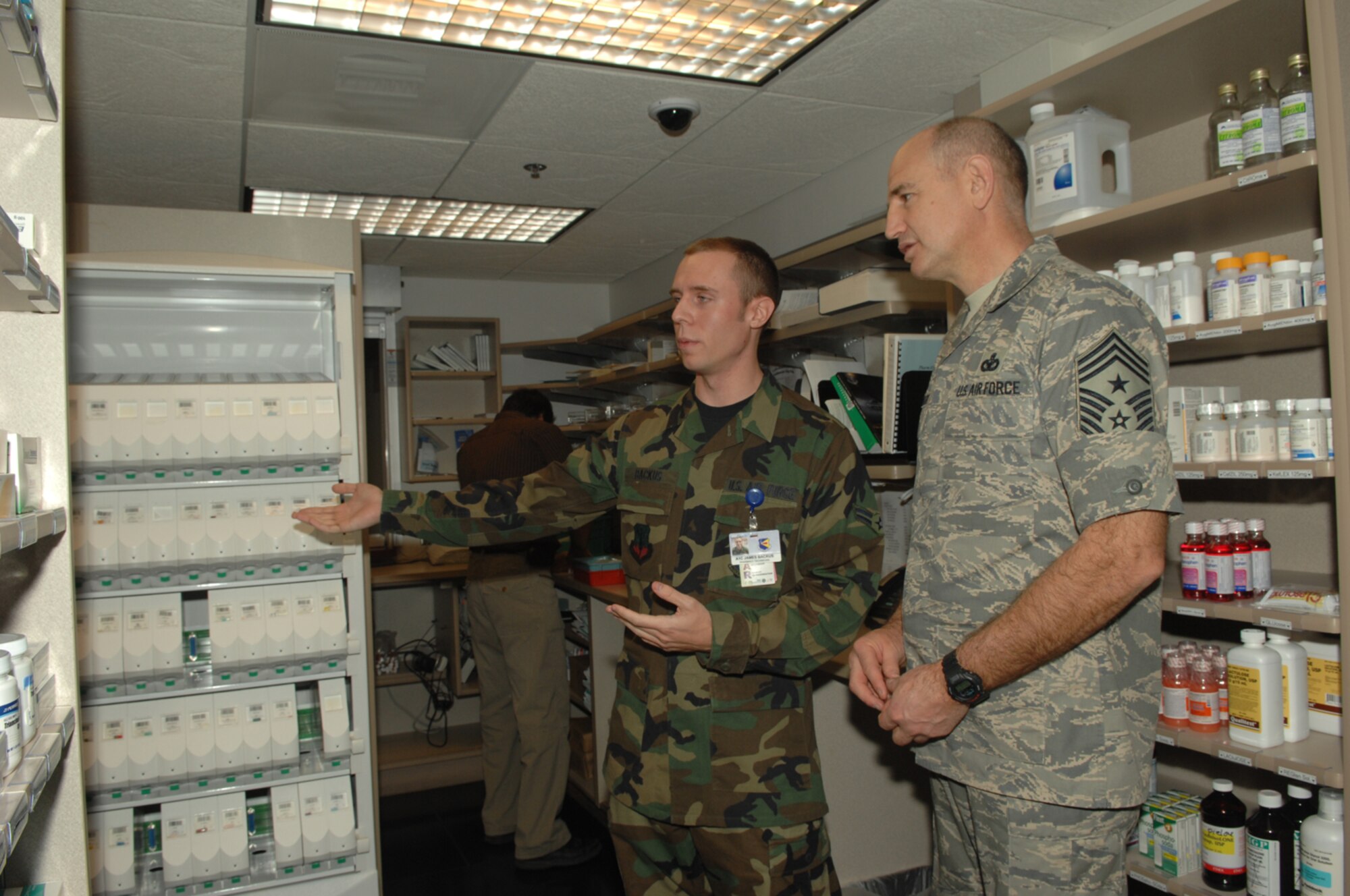 Chief Master Sgt. Stephen Sullens, Air Combat Command command chief, took a tour of the 355th Medical Group April 9 during his visit to D-M. While at the medical group Chief Sullens was briefed on the different operations of the base hospital. Here the chief was briefed by Airman 1st Class James Backus, 355th Medical Support Squadron pharmacy technician, on the operations of the base pharmacy. (U.S. Air Force photo by Senior Airman Alesia Goosic)