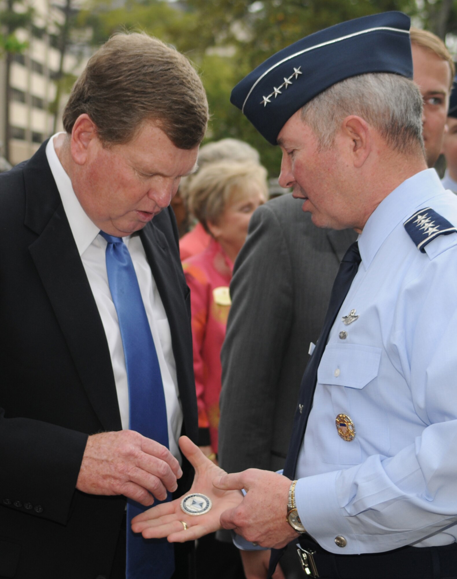 Jamie Sablich receives a vice chief of staff coin from General McNabb at the reopening of Sablich Center April 3. Sergeant Sablich, for whom the building is named, was Jamie’s’ uncle.