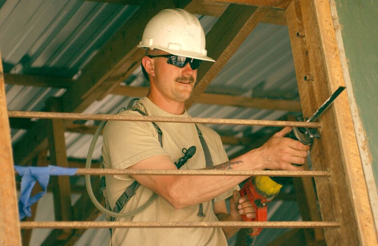 LAS MESAS, Honduras - A U.S. Army engineer cuts steel bars from a dilapidated schoolhouse window as part of Beyond the Horizon, an exercise that provides infrastructure renovation, as well as basic medical and dental care, to rural areas of this Central American country. Soldiers from the 672nd, 756th, and 1430th Engineer Companies are working at Las Mesas during the joint forces training exercise Beyond the Horizon. They will replace the school?s doors and windows, repair the roof, and repaint the entire structure, in addition to improving a soccer field on which local children play. (Photo by Sgt. Claude W. Flowers, 304th Public Affairs Detachment.)            