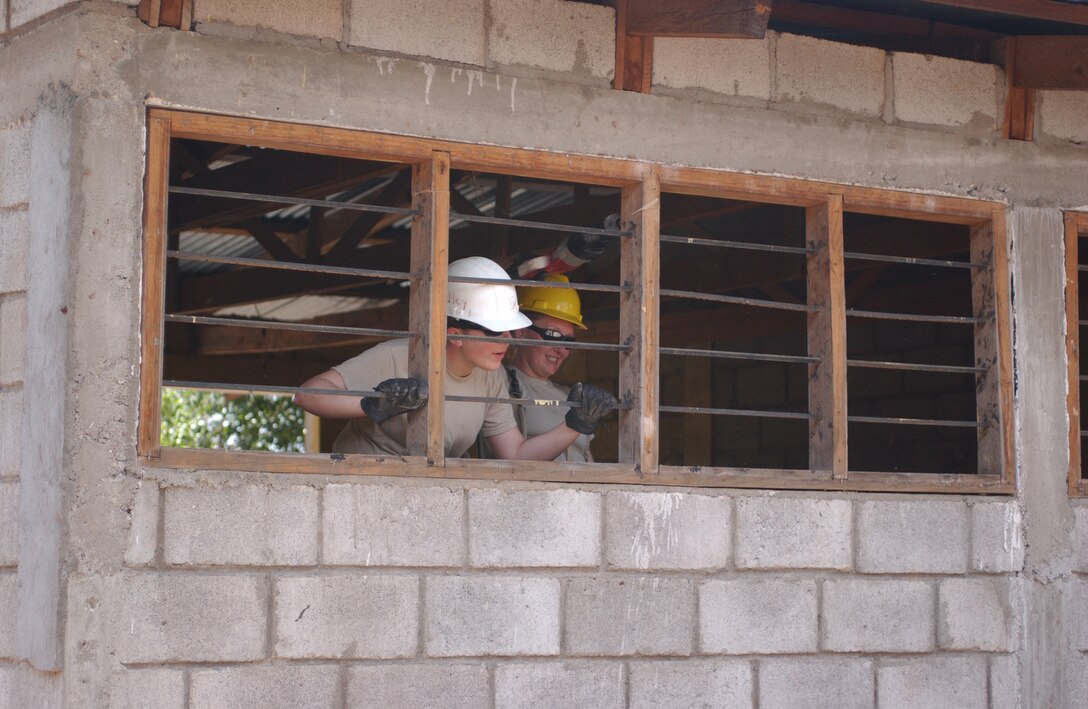LAS MESAS, Honduras - U.S. Army engineers prepare to remove a dilapidated schoolhouse window as part of Beyond the Horizon, an exercise that provides infrastructure renovation, as well as basic medical and dental care, to rural areas of this Central American country. Soldiers from the 672nd, 756th, and 1430th Engineer Companies are working at Las Mesas during the joint forces training exercise Beyond the Horizon. They will replace the school's doors and windows, repair the roof, and repaint the entire structure, in addition to improving a soccer field on which local children play. (Photo by Sgt. Claude W. Flowers, 304th Public Affairs Detachment.)