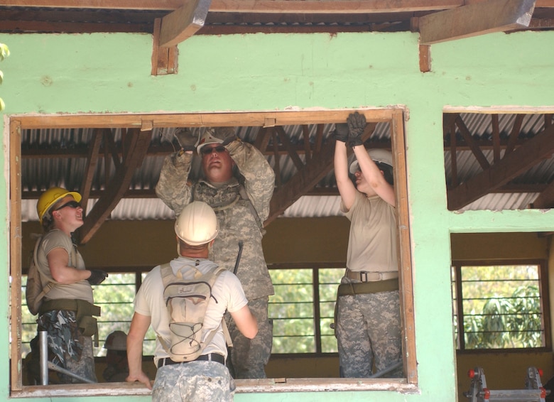 4/1/2008 - LAS MESAS, Honduras - U.S. Army engineers remove a dilapidated schoolhouse window as part of Beyond the Horizon, an exercise that provides infrastructure renovation, as well as basic medical and dental care, to rural areas of this Central American country. Soldiers from the 672nd, 756th, and 1430th Engineer Companies are working at Las Mesas during the joint forces training exercise Beyond the Horizon. They will replace the school's doors and windows, repair the roof, and repaint the entire structure, in addition to improving a soccer field on which local children play. (Photo by Sgt. Claude W. Flowers, 304th Public Affairs Detachment.)
