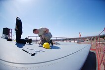 Technical Sgt. Shawn Connolly and Senior Airman Christopher Snodderley de-panel the t-tail of one of Westover's C-5's as part of the isochronical inspection process.