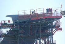 Isocronical Dock maintenance members work atop the t-tail of one of Westover's C-5's as part of the aircraft inspection process