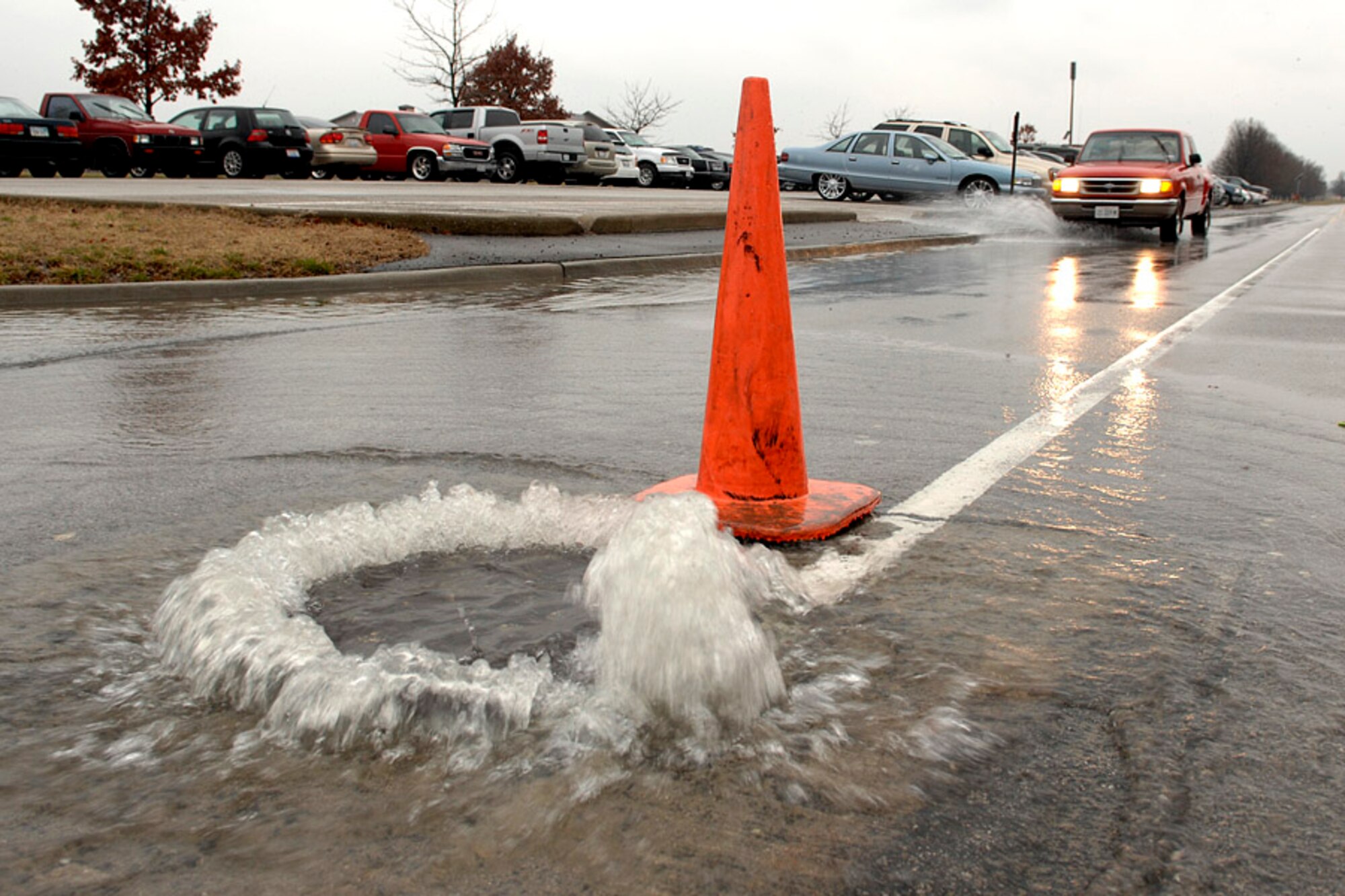 SCOTT AIR FORCE BASE, Ill. -- A car approaches a flooding man hole near building 700 March 19. (U.S. Air Force photo/Airman 1st Class Megan Gilliland)