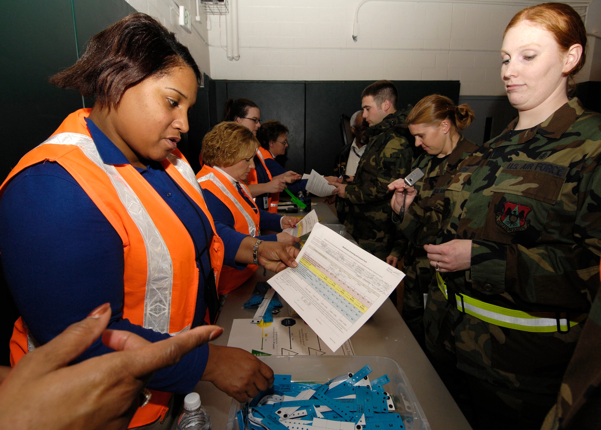 SCOTT AIR FORCE BASE, Ill. -- Belinda Clark, Fairview Heights Health Department case manager, inspects Staff Sgt. Candice Melton’s paperwork to determine the severity of her condition during the Strategic National Stockpile Exercise. (U.S. Air Force photo/ Senior Airman Mildred Guevara)