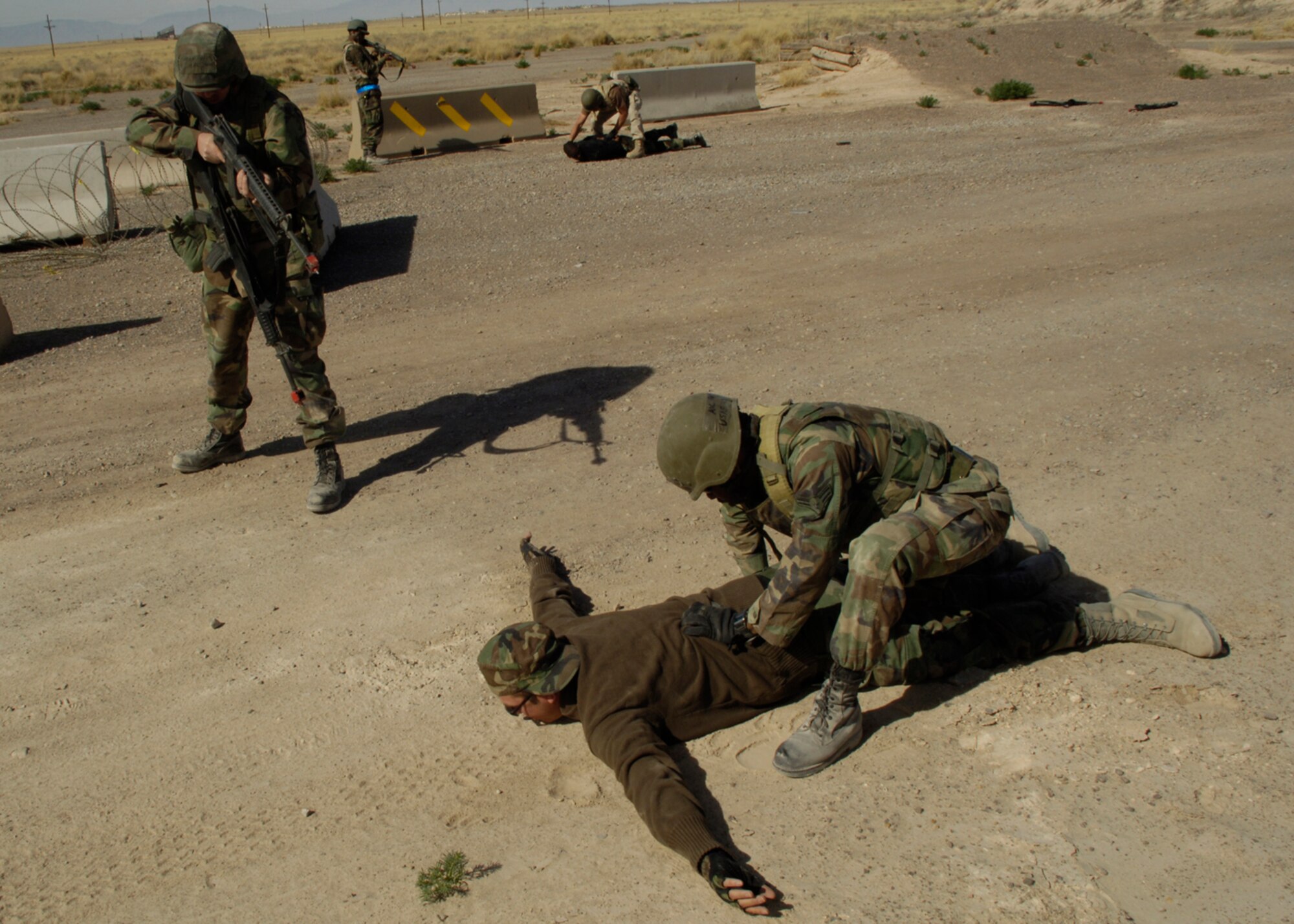 HOLLOMAN AIR FORCE BASE, N.M. -- Airman 1st Class Lakeif Ferron, 49th Civil Engineer Squadron, searches a suspect played by Senior Airman Norman Luper, 49 CES, while Staff Sgt. Jason Able over sees during the phase two exercise here April 2 . (U.S. Air Force photo/Airman 1st Class Michael J. Means)