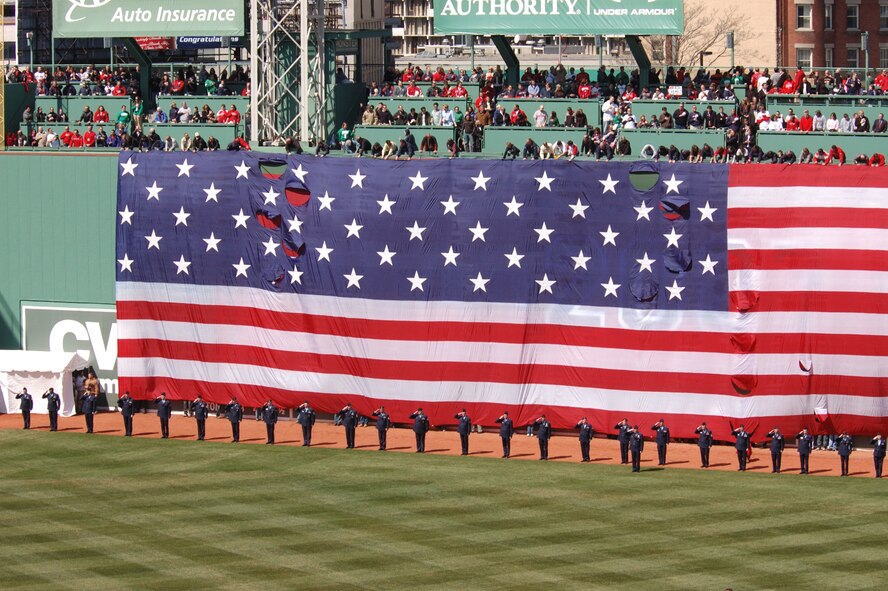 HANSCOM AFB, Mass. – Hanscom Airmen render honors during the playing of the National Anthem on April 8 at Fenway Park during the Boston Red Sox home opener. The Airmen were on the field as part of the Opening Day ceremonies.  (U.S. Air Force photo by Walter Santos)