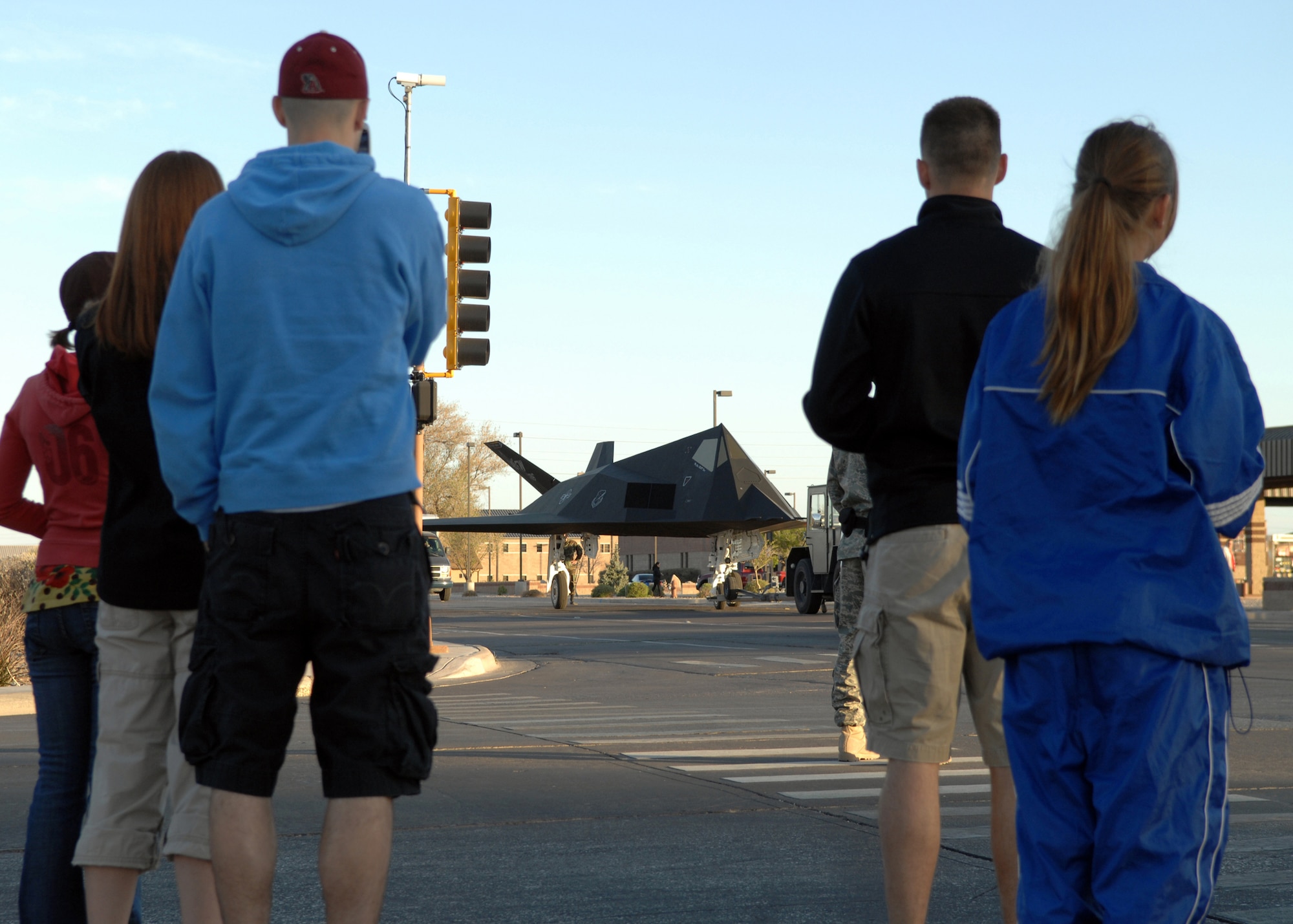 HOLLOMAN AIR FORCE BASE, N.M. -- Bystanders stare at sight they don?t see everyday; an F-117A being towed down the street here April 5. The F-117A was being pulled by a tow tractor to be put on display at the Heritage Park in preparation for its retirement. (U.S. Air Force photo by Airman Sondra M. Wieseler)