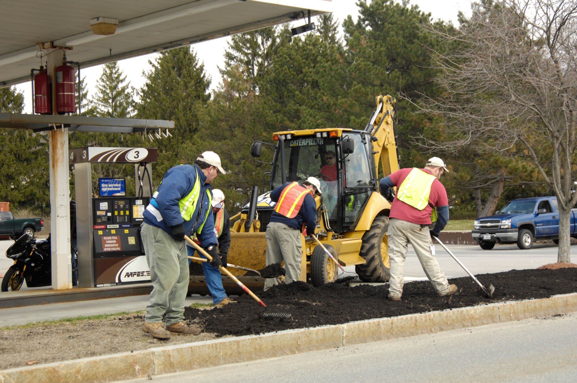 HANSCOM AFB, Mass. – IAP employees spread organic compost on a median outside of the AAFES service station on April 7. The recent mild temperatures have allowed maintenance crews to accomplish some outside work in preparation for future grass re-seeding projects around the base. (U.S. Air Force photo by Linda LaBonte Britt)


