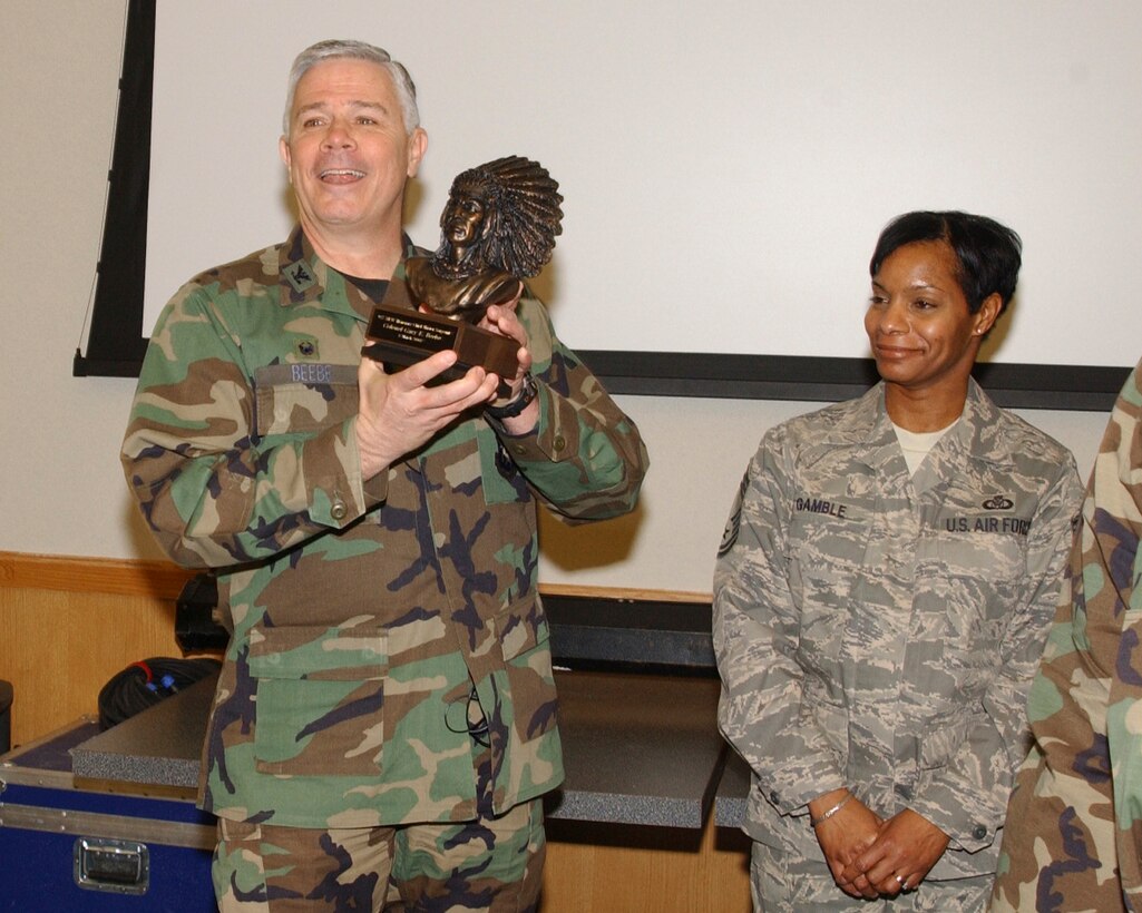 Col. Gary Beebe, 927ARW commander, displays his newly presented Honorary Chief Master Sergeant bust as CMSgt Rose Gamble looks on.                              
