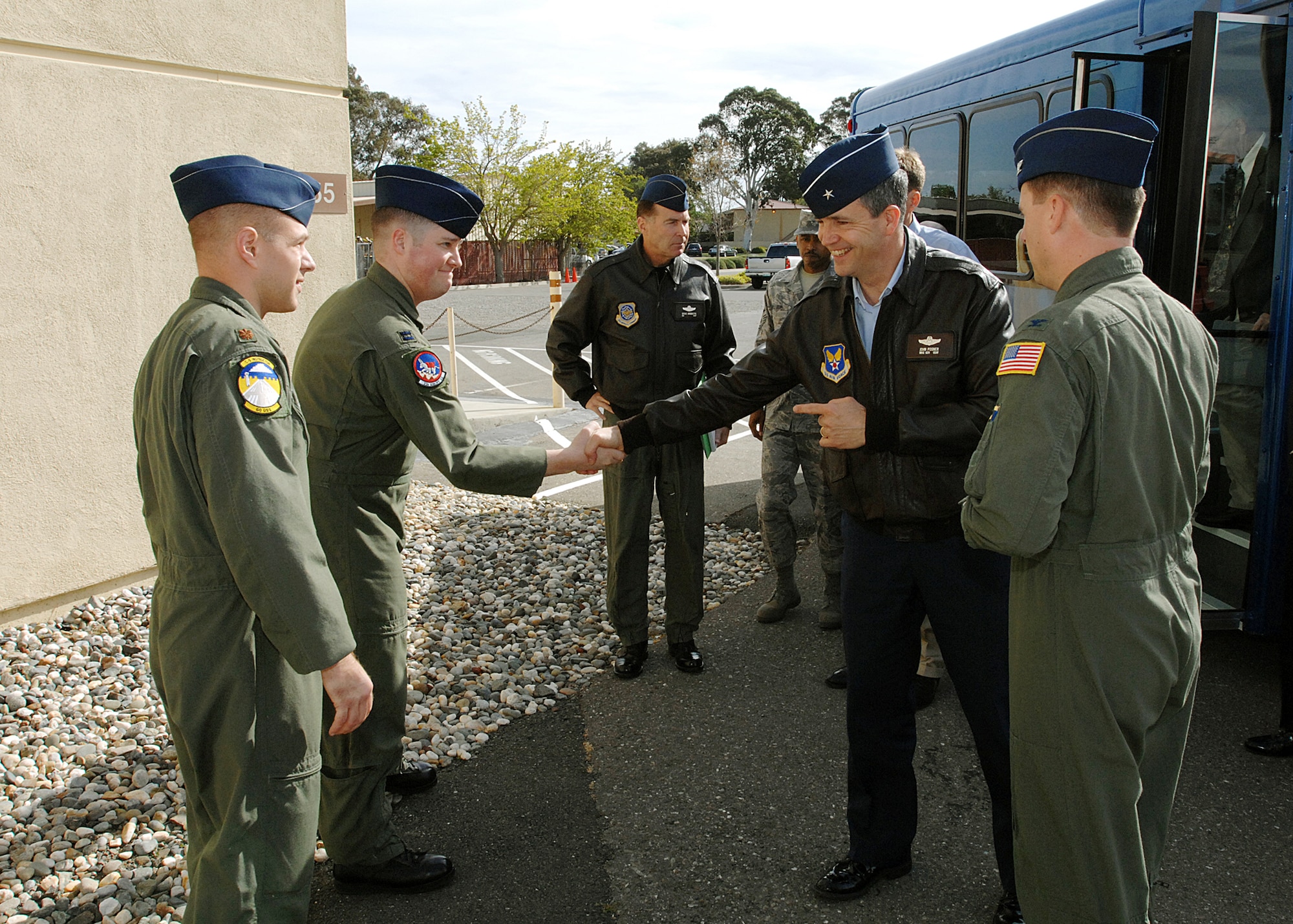 Brigadier General John Posner, Director, Air Force Smart Operations, Office of the Secretary of the Air Force, is greeted by Capt. Scott Knerr, 60 Operations Group AFSO21 Process Manager, upon his arrival at the C-5 Simulator training facility at Travis AFB, CA. Also pictured are Col. Steven Arquiette, 60 AMW Commander (in background), Col. John Wood, 60 Operations Group Acting Commander (right foreground) and Maj. Ryan Aerni, 60 Operations Group Executive Officer (left foreground). Brigadier General Posner, along with Dr. Ron Ritter, Special Assistant for Air Force Smart Operations to the Secretary of the Air Force/Deputy Director, Air Force Smart Operations, Office of the Secretary of the Air Force, were visiting Travis AFB to receive a series of briefings on current AFSO21 initiatives being carried out by Travis Airmen. Travis AFB CA U.S. Air Force Photo by David W. Cushman, DAFC