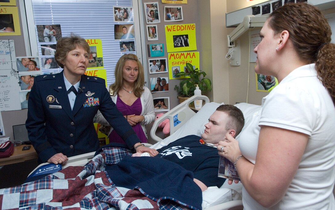 Brig. Gen. Michelle D. Johnson talks with Ivoan Thompson, the wife of wounded Navy Corpsman Anthony Thompson April 5 at the James A. Haley Veterans' Hospital in Tampa, Fla.  General Johnson along with cheer and dance squads from the 2008 Women's Final Four basketball teams visited the hospital to share smiles and stories with retired and active duty members and their families.  (U.S. Air Force photo/Staff Sgt. Bennie J. Davis III)