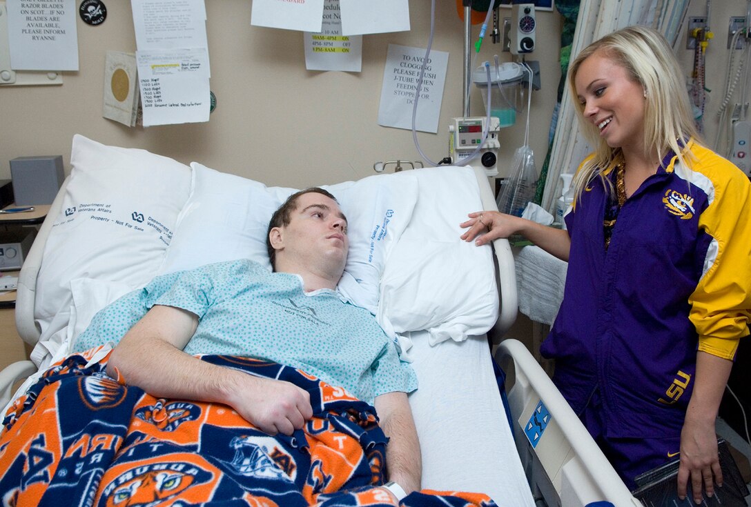 Christina Caporella, a member of the  Louisiana State University Tigers girls dance team, talks with a wounded warrior during an April 5 visit to the James A. Haley Veterans' Hospital in Tampa, Fla. The Lady Tigers, along with cheer and dance squads from the other three 2008 Women's Final Four basketball teams, spent the afternoon sharing smiles and stories with retired and active duty members and their families. (U.S. Air Force photo/Staff Sgt. Bennie J. Davis III) 

