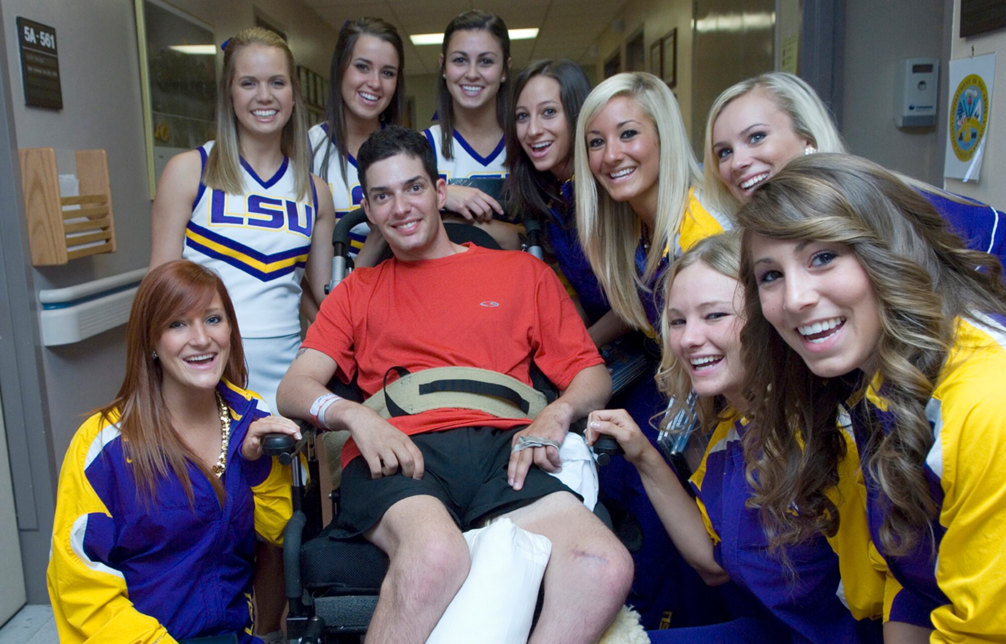 Members of the Louisiana State University Tigers dance team and cheerleading squad put a smile on the face of Army Sgt. Mark Lalli April 5 at the James A. Haley Veterans' Hospital in Tampa, Fla. The Lady Tigers made a special visit to lift the spirits of patients. LSU, along with cheer and dance squads from the other three 2008 Women's Final Four teams, spent the afternoon sharing smiles and stories with retired and active duty members and their families. (U.S. Air Force photo/Staff Sgt. Bennie J. Davis III) 

