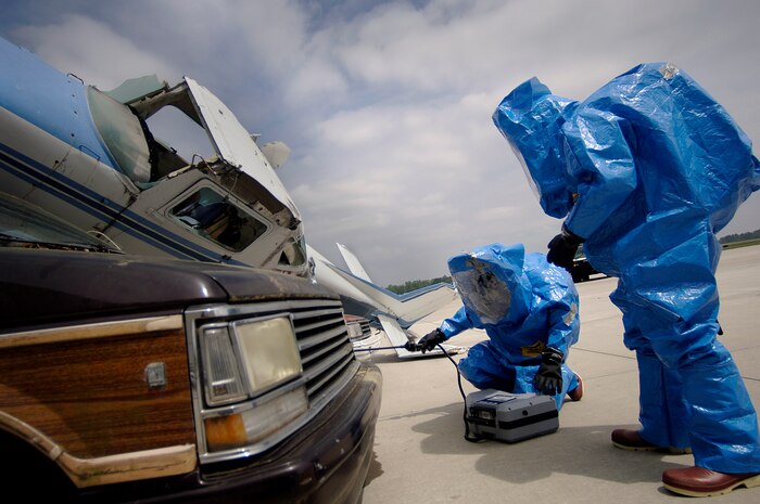 Senior Airman Levi Lux and Airman 1st Class D'Andre Boston test the air around the area of the simulated crash on the Charleston AFB flightline Tuesday during an exercise in preparation for the 2008 "Wings Over Charleston" Air Show. Airmen Lux and Boston are with the 437th Medical Group Bioenvironmental Engineering Flight. (U.S. Air Force photo/Senior Airman Nicholas Pilch)
