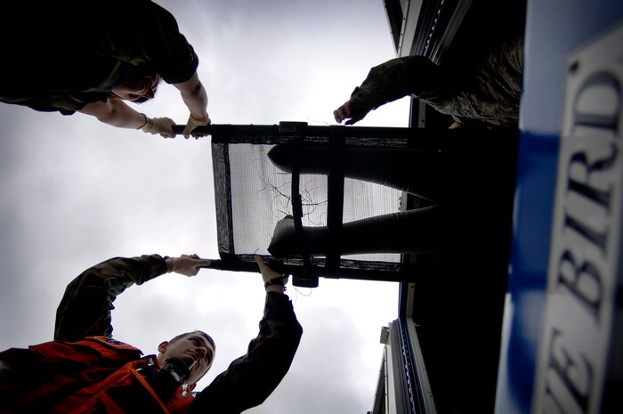 Airmen from the 437th Medical Group load a bus with medical mannequins on the Charleston AFB flightline Tuesday. They loaded the mannequins so they could be evacuated as part of the exercise in preparation for the 2008 "Wings Over Charleston" Air Show. (U.S. Air Force photo/Senior Airman Nicholas Pilch)