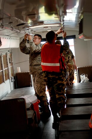Airmen from the 437th Medical Group prepare to load a bus with medical mannequins on the Charleston AFB flightline Tuesday. They loaded the mannequins so they could be evacuated as part of the exercise in preparation for the 2008 "Wings Over Charleston" Air Show. (U.S. Air Force photo/Senior Airman Nicholas Pilch)