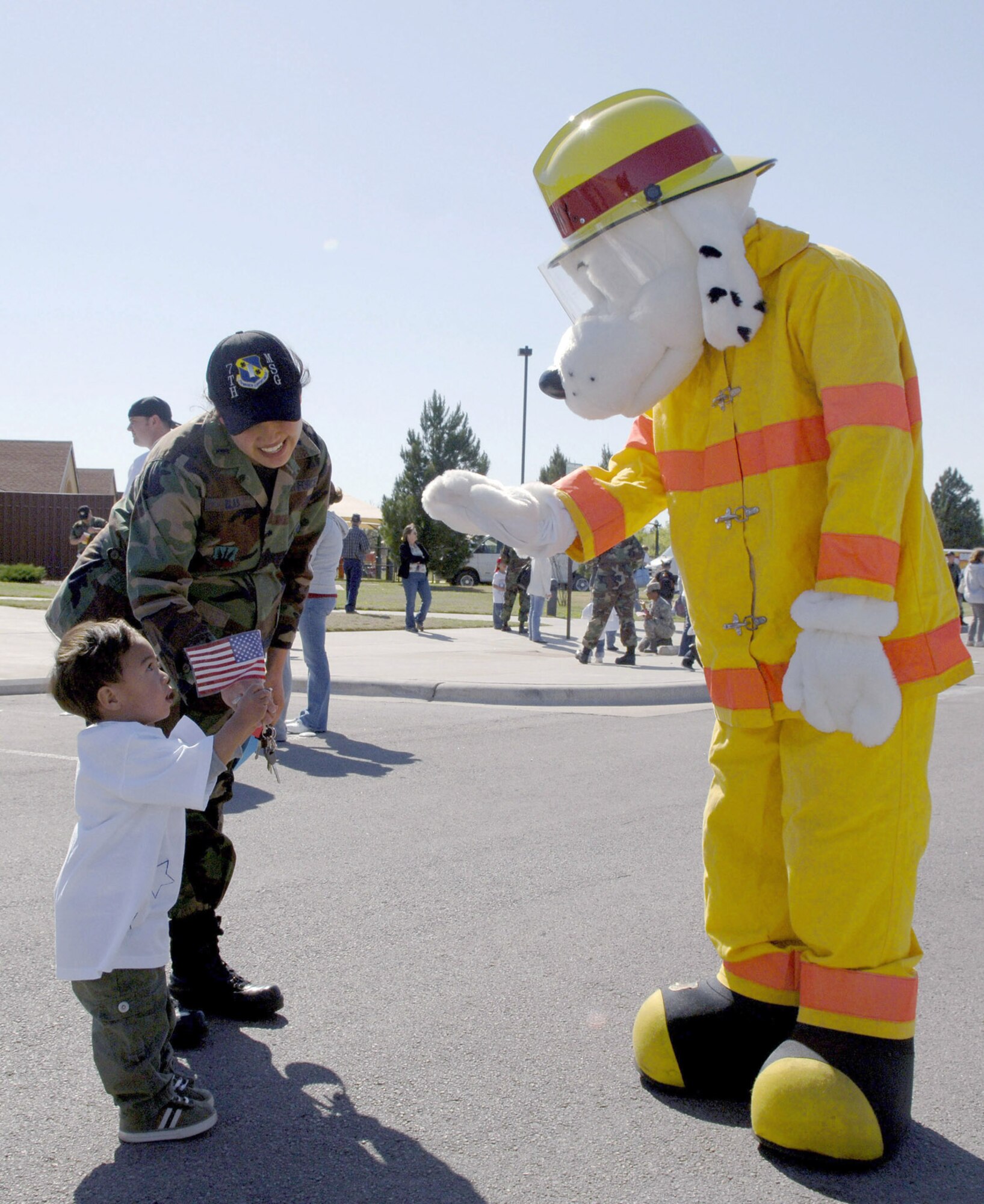 DYESS AIR FORCE BASE, Texas --First Lieutenant Jomia Blas, 7th Mission Support Group, encourages her 2-year-old son, Darrin, to say hi to Sparky the fire dog during the Month of Military Child parade April 4.  The parade will be followed by other events in April celebrating and recognizing that the children of Dyess military personnel are vital to the mission success of the base.  (U.S. Air Force photo by Staff Sergeant Connor W. Estes)