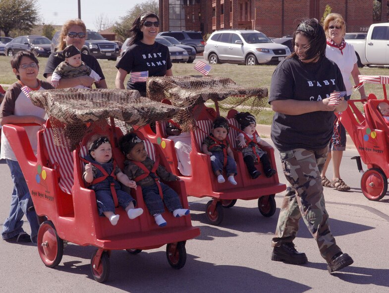 DYESS AIR FORCE BASE, Texas -- The 6 weeks to 6 months old class demonstrate that they are in Baby Camp by showing off their camouflage bandanas during the Month of Military Child parade April 4.  More than 200 children assigned to the Child and Development Center let their voices be known as they strolled down the streets of Dyess AFB.  This will be one of many events in April sponsored by the 7th Services for the Month of the Military Child held on Dyess AFB.  (U.S. Air Force photo by Staff Sergeant Connor W. Estes)